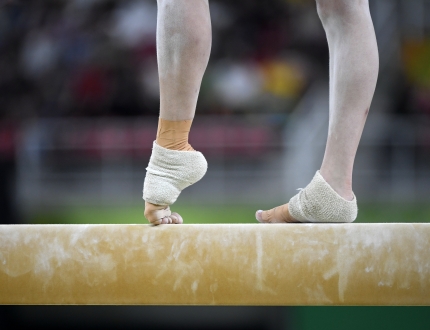 a gymnastics feet on the bar