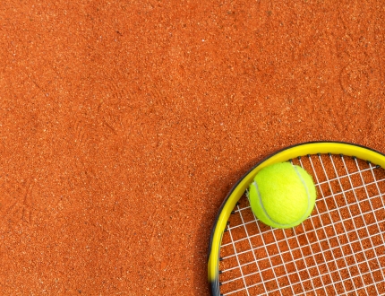 tennis equipment on a brown surface