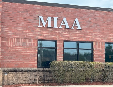 Exterior of a brick building with the lettering MIAA