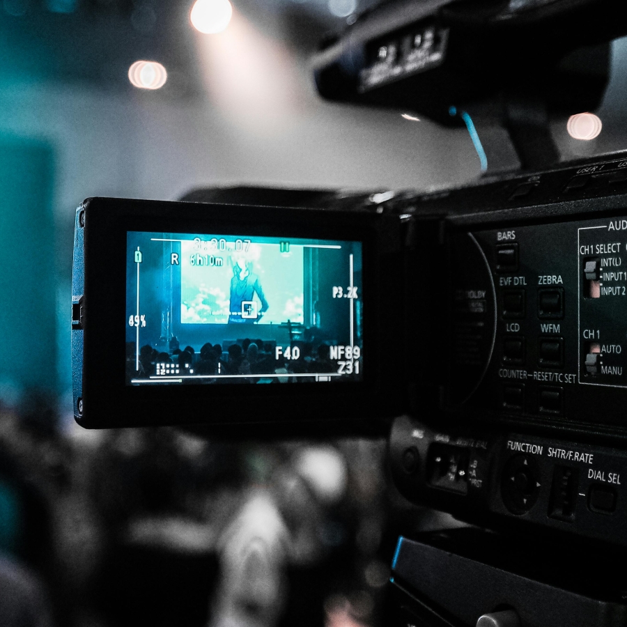 a professional video camera recording something in the distance