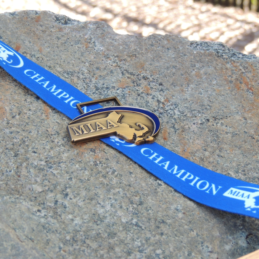 a lanyard holding a pin of MIAA